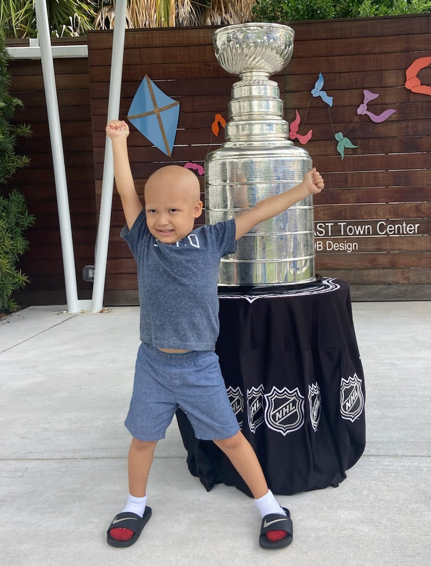 Kameron Bush, 3, poses with the Stanley Cup at the Children’s Cancer Center in Tampa, Fla., on Oct. 16, 2020. The Tampa Bay Lightning took the Stanley Cup to the Children’s Cancer Center as part of their local tour of stops after winning the National Hockey League’s championship trophy Sept. 28 in Edmonton, Alberta. (Kristina Hjertkvist/Tampa Bay Lightning via AP)