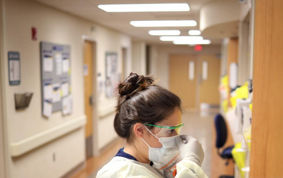 A nurse in the COVID-19 unit of MedStar St. Mary's Hospital check the fit of protective equipment before entering a patient's room March 24, 2020 in Leonardtown, Maryland.