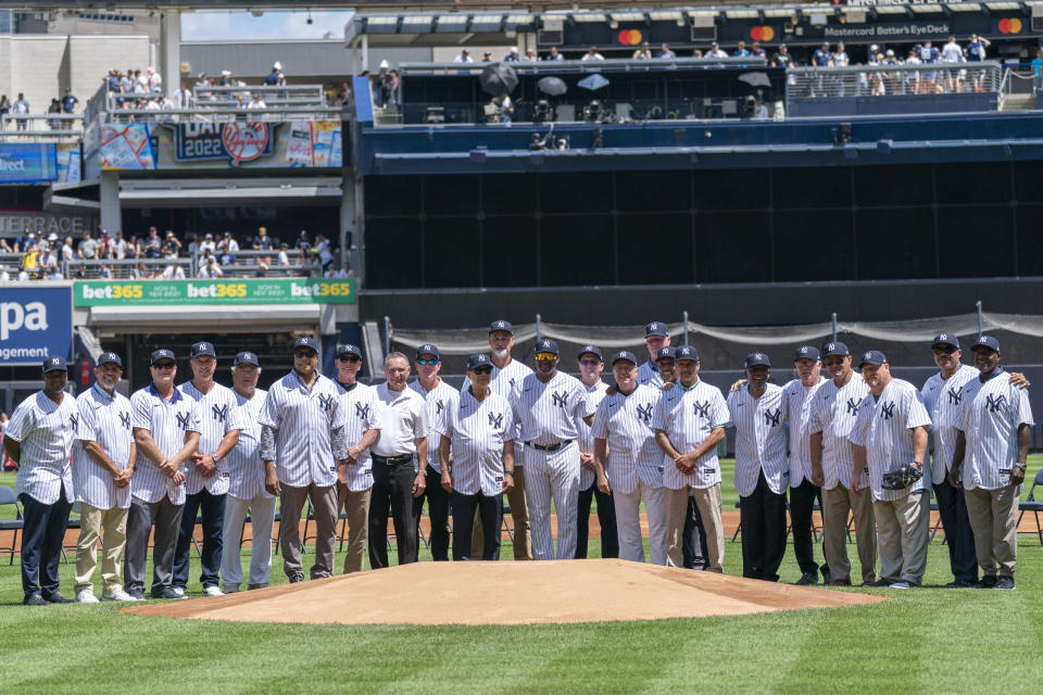 Former New York Yankees players pose for a photo during the Old-Timers' Day ceremony before the start of a baseball game between the New York Yankees and the Kansas City Royals, Saturday, July 30, 2022, in New York. (AP Photo/Mary Altaffer)