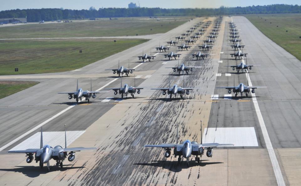 70 F-15E Strike Eagles take part in a large-scale readiness exercise, or 'Elephant Walk," at Seymour Johnson Air Force Base in North Carolina in 2012. <em>USAF</em>
