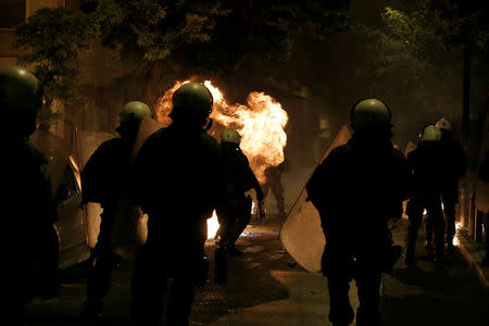 A petrol bomb explodes next to riot police during clashes following an anniversary rally marking the 2008 police shooting of 15-year-old student, Alexandros Grigoropoulos, in Athens, Greece, December 6, 2017. REUTERS/Alkis Konstantinidis