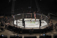 Michelle Waterson, center left, and Carla Esparza battle without spectators during a UFC 249 mixed martial arts bout, Saturday, May 9, 2020, in Jacksonville, Fla. (AP Photo/John Raoux)