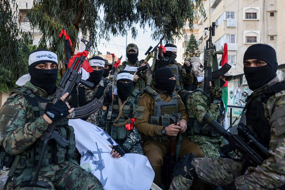 Palestinians Hamas militants wear headbands that say in Arabic 