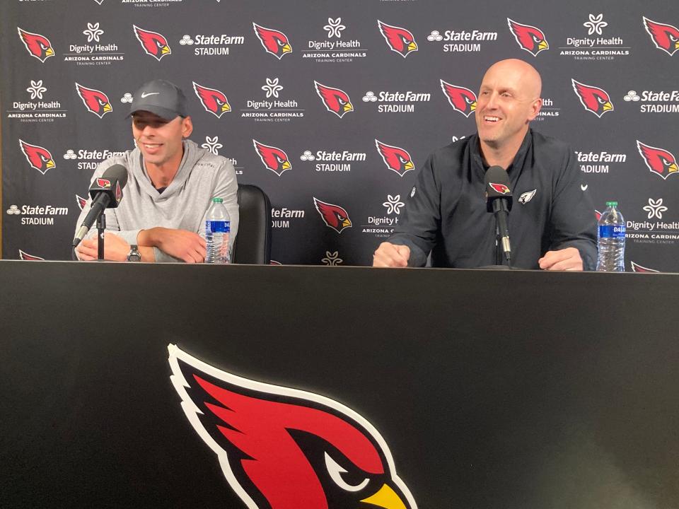 Arizona Cardinals head coach Jonathan Gannon (left) and general manager Monti Ossenfort laugh with members of the media on March 20 at the team's facility.