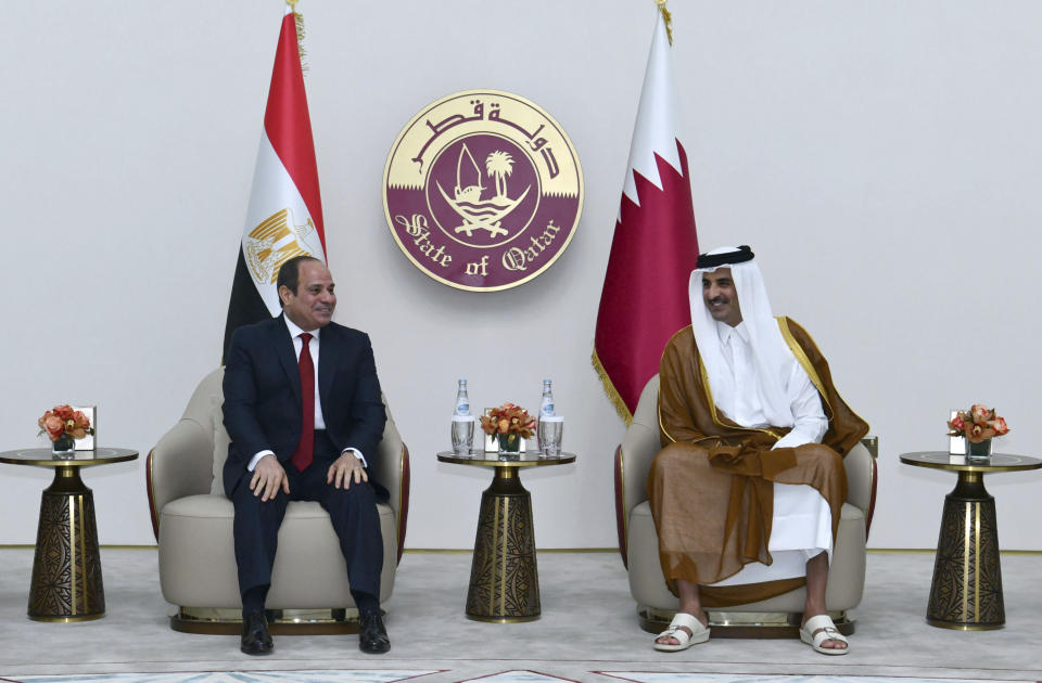 In this photo provided by Egypt's presidency media office, Qatari Emir Tamim bin Hamad Al Thani, right, meets with Egyptian President Abdel-Fattah el-Sissi, upon his arrival in Doha, Qatar, Tuesday, Sept.13, 2022. Egypt’s president travelled on Tuesday to Qatar on his first visit to the gas-rich nation amid warming ties after years of frayed relations following the Egyptian military’s overthrow of an Islamist president backed by Doha. (Egyptian Presidency Media Office via AP)