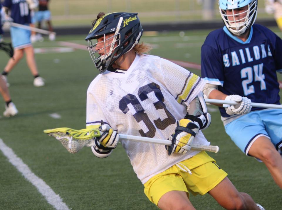 Hartland's Jack Sargeant handles the ball during a 21-3 victory over Muskegon Mona Shores in a state Division 1 lacrosse quarterfinal Friday, June 2, 2023 at Parker Middle School.