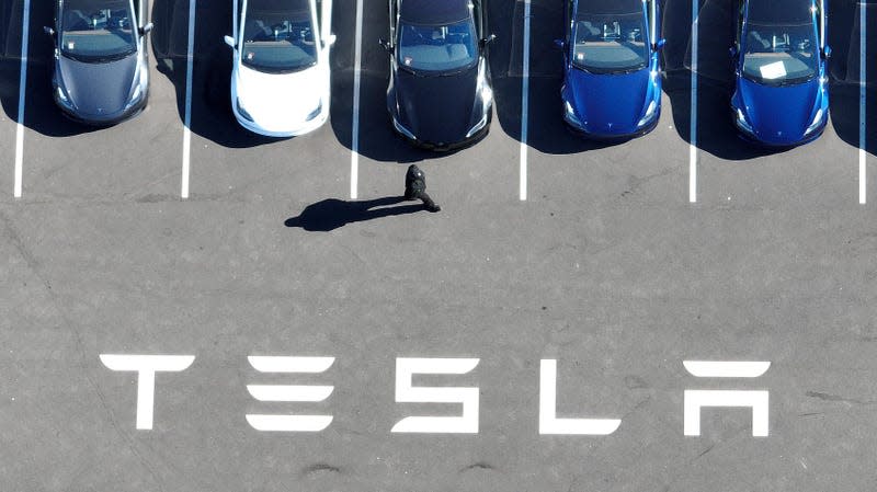 In an aerial view, brand new Tesla cars sit in a parking lot at the Tesla factory on October 19, 2022 in Fremont, California.