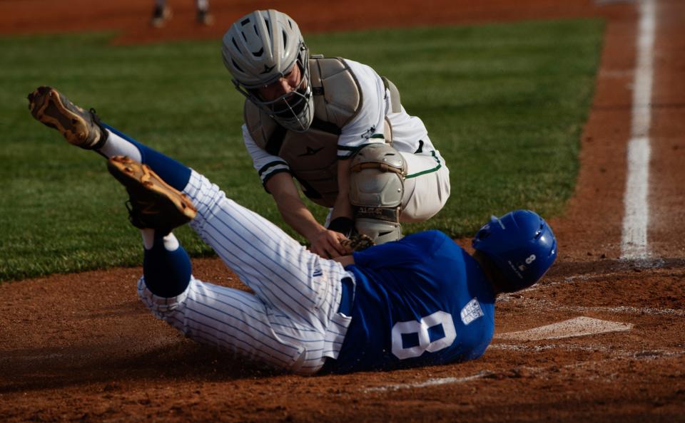 Memorial's Ryan Pietruszkiewicz (8) is tagged out at the plate by North's	Gabe Wilke (8) during their game at North High School's Husky Field Thursday evening, April 13, 2023.