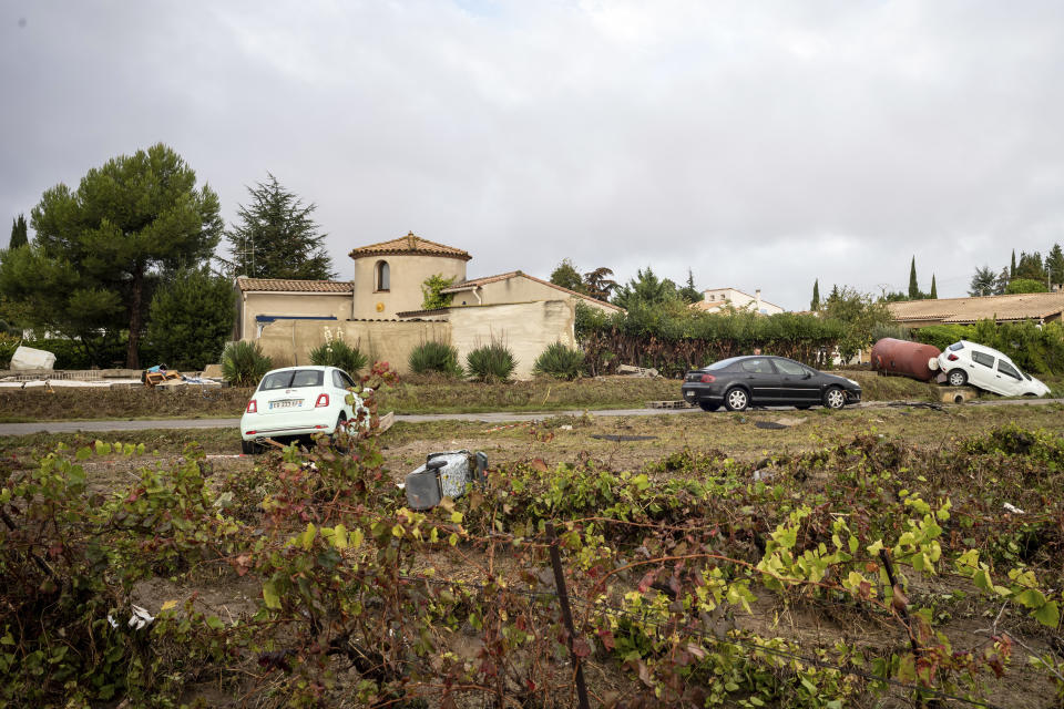 Cars are pictured in a vineyard in the town of Villegailhenc, southern France, Monday, Oct.15, 2018. Flash floods tore through towns in southwest France, turning streams into raging torrents that authorities said killed several people and seriously injured at least five others. (AP Photo/Fred Lancelot)