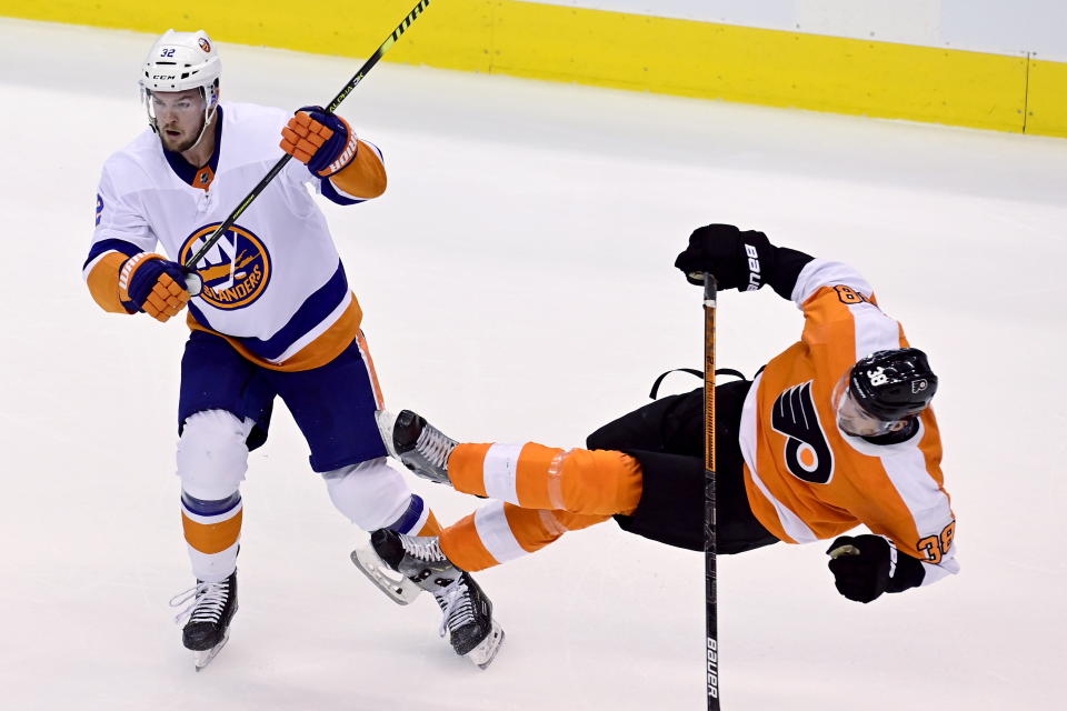 New York Islanders defenseman Adam Pelech (3) levels Philadelphia Flyers center Derek Grant (38) during first-period NHL Stanley Cup Eastern Conference playoff hockey game action in Toronto, Monday, Aug. 24, 2020. (Frank Gunn/The Canadian Press via AP)