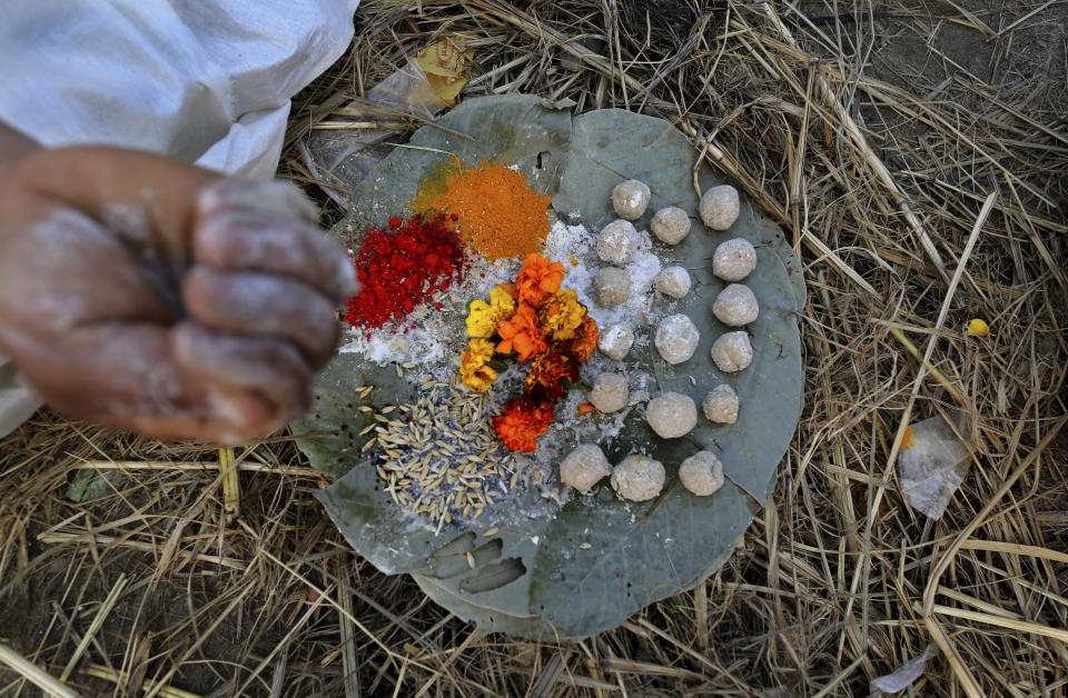 In this Feb. 6, 2019, photo, a Hindu man performs rituals before becoming Naga Sadhu or naked holy man at Sangam, the confluence of three holy rivers during the Kumbh Mela or pitcher festival in Prayagraj Uttar Pradesh state, India. At every Kumbh, including this year's, thousands of devotees were initiated into the reclusive sect of the Naga Sadhus, naked, ash-smeared cannabis-smoking Hindu warriors and onetime-armed defenders of the faith who for centuries have lived as ascetics in jungles and caves. (AP Photo/ Rajesh Kumar Singh)