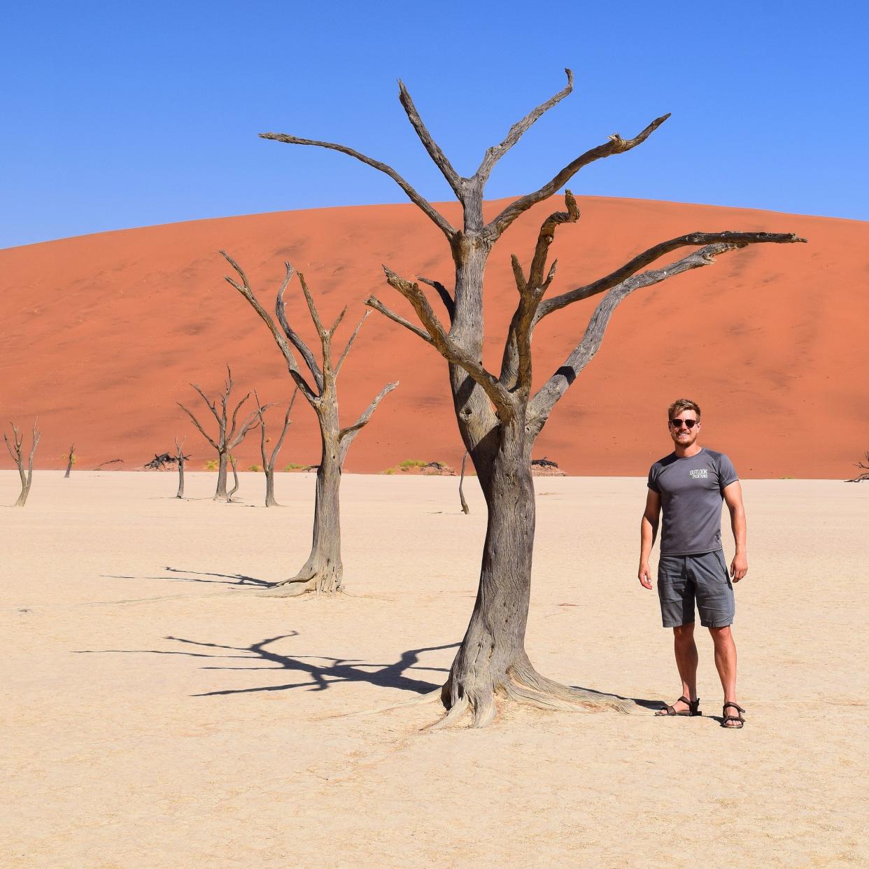 Man standing next to tree