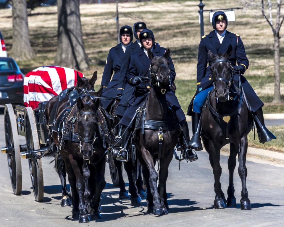 A burial at Arlington National Cemetery in Virginia, with a coffin carried on horse-drawn caisson.   March 26, 2018. / Credit: Visions of America/Universal Images Group via Getty Images