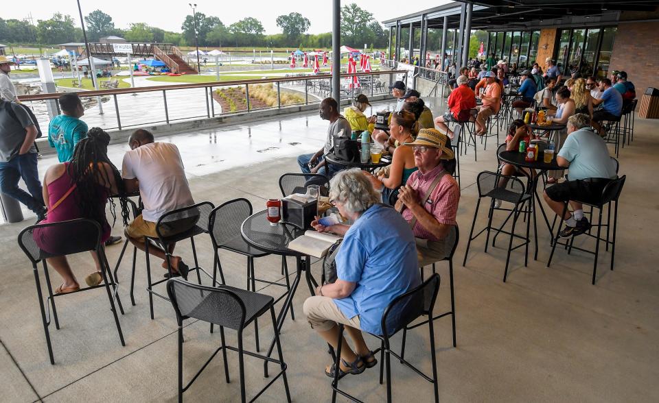 Spectators wait out a weather delay during the opening weekend at Montgomery Whitewater in Montgomery, Ala., on Saturday July 8, 2023.