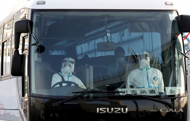 A bus believed to be carrying passengers from the cruise ship Diamond Princess, leaves Daikoku Pier Cruise Terminal in Yokohama