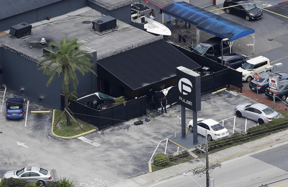 FILE - Law enforcement officials work at the Pulse nightclub in Orlando, Fla., on June 12, 2016, following a mass shooting. The shooter targeted gay patrons in what was a largely Latino crowd. The shooting at a supermarket in Buffalo, New York, on Saturday, May 14, 2022, is the latest example of something that's been part of U.S. history since the beginning: targeted racial violence. (AP Photo/Chris O'Meara, File)