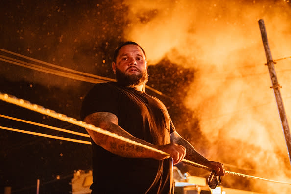 A man looks over caution tape during a second night of rioting on in Kenosha, Wisconsin. 