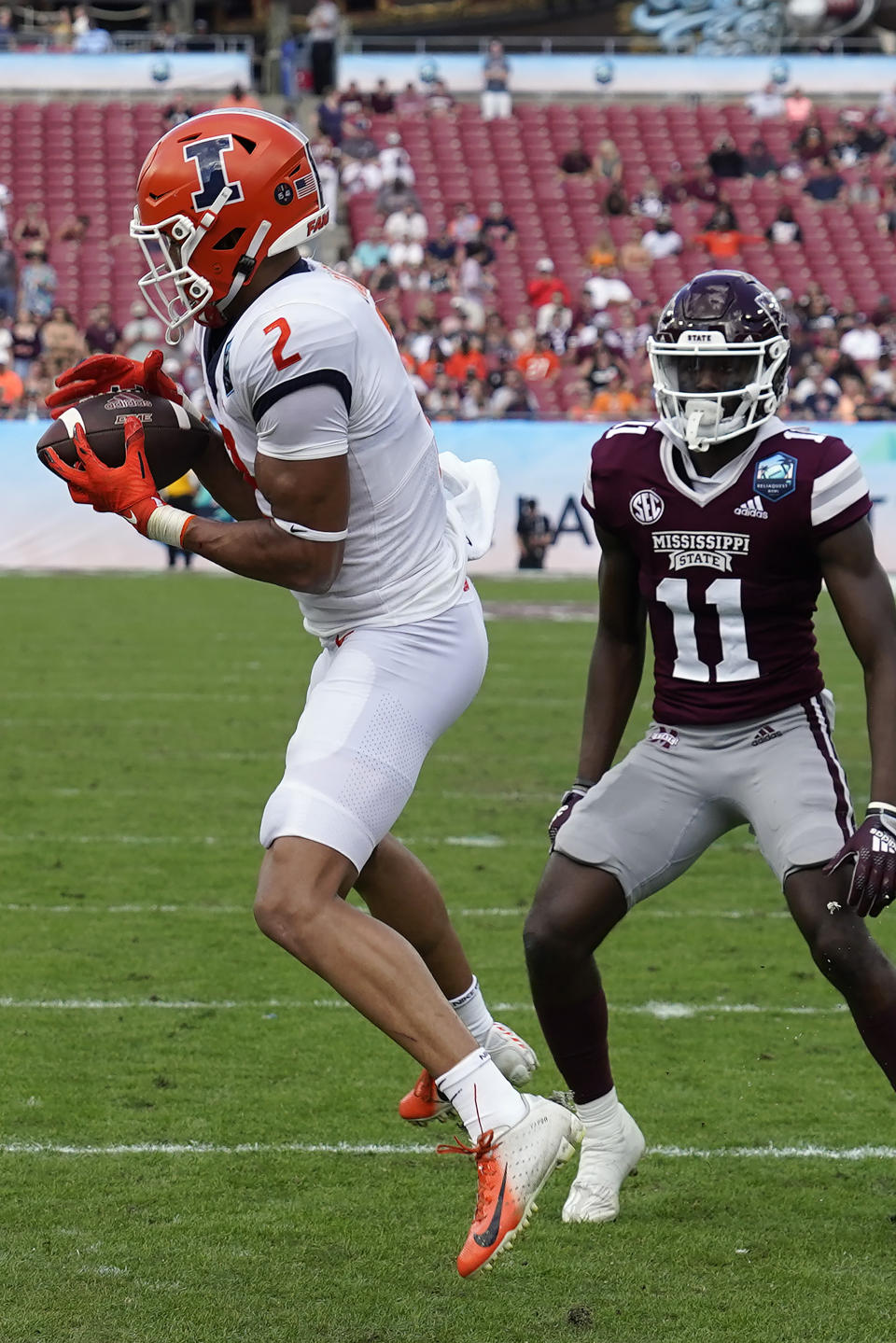 Illinois defensive back Matthew Bailey (2) intercepts a Mississippi State pass during the first half of the ReliaQuest Bowl NCAA college football game Monday, Jan. 2, 2023, in Tampa, Fla. Looking on is wide receiver Jaden Walley (11). (AP Photo/Chris O'Meara)