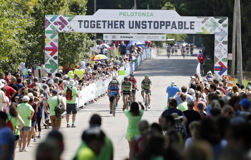 Riders make their way to the Pelotonia finish line at Kenyon College during the Pelotonia in 2019.