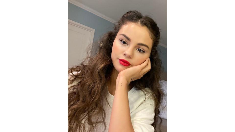 Selena Gomez shares a selfie wearing red lipstick