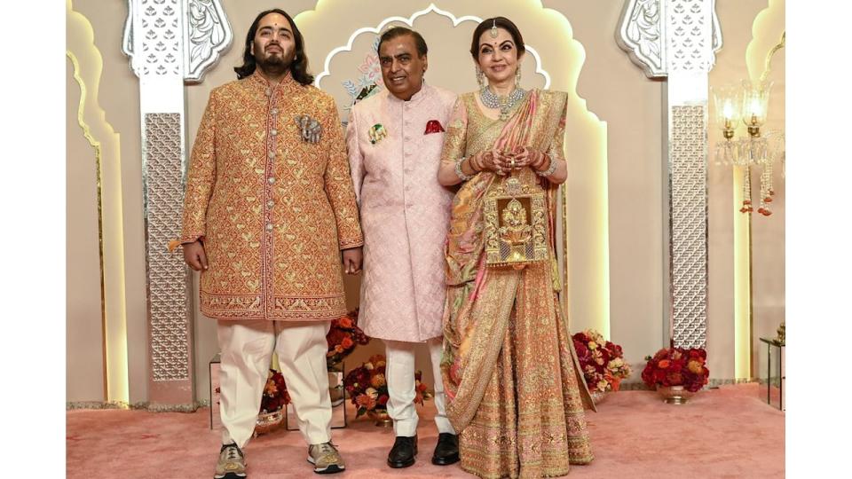 Nita and Mukesh Ambani with their son Anant posed for photos as they arrived to attend the wedding ceremony 