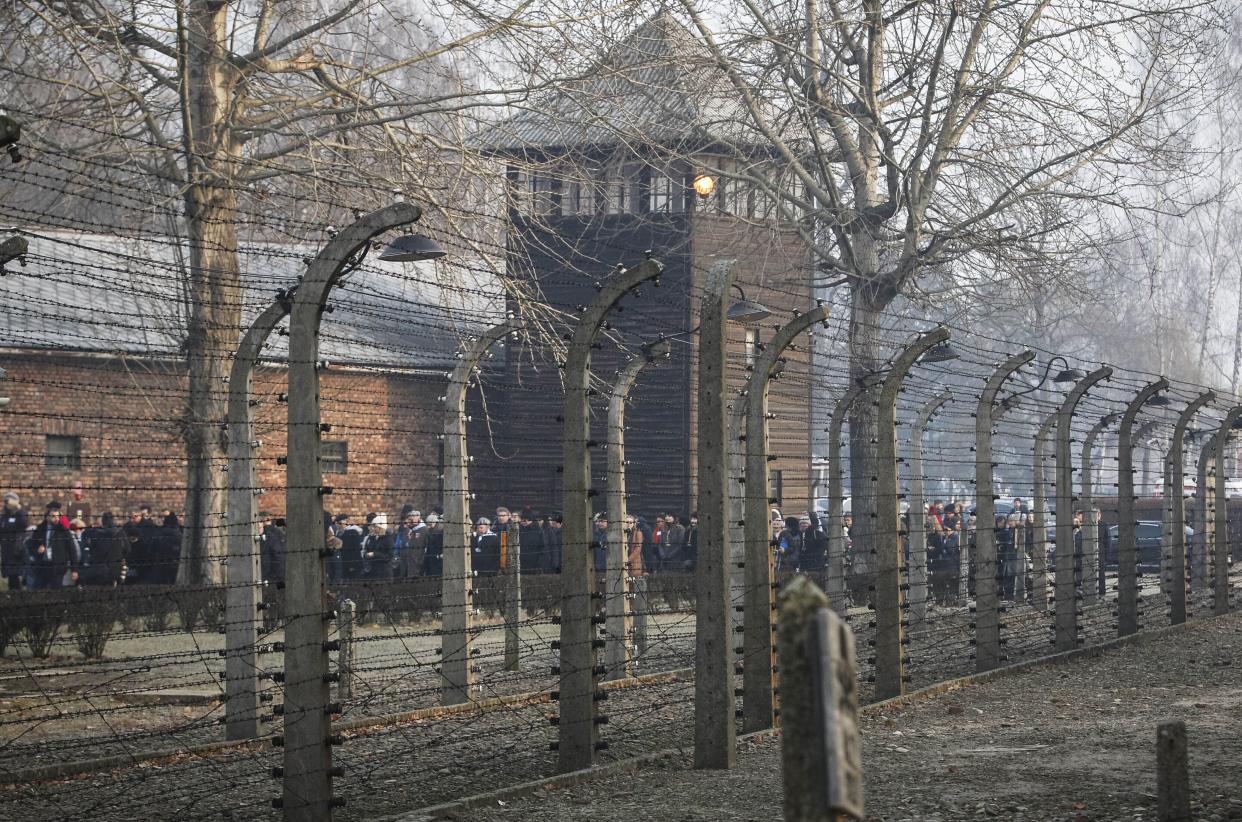 In this photo taken Jan. 27, 2020, people are seen arriving at the site of the Auschwitz-Birkenau Nazi German death camp, in Oswiecim, Poland, for observances marking 75 years since the camp's liberation by the Soviet army.