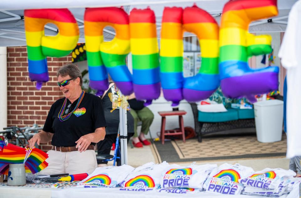 Ginger Scott laughs as she runs the festival booth during the first annual Loogootee Pride Festival on Saturday, June 10, 2023.