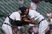 Detroit Tigers catcher Jake Rogers and relief pitcher Alex Lange meet after the ninth inning of a baseball game against the Texas Rangers, Wednesday, May 31, 2023, in Detroit. (AP Photo/Carlos Osorio)