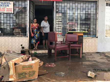 REFILE - CORRECTING DATE People stand outside a business after flooding from Tropical Cyclone Josie in Ba, Fiji April 2, 2018 in this image obtained from social media. Naziah Ali via REUTERS