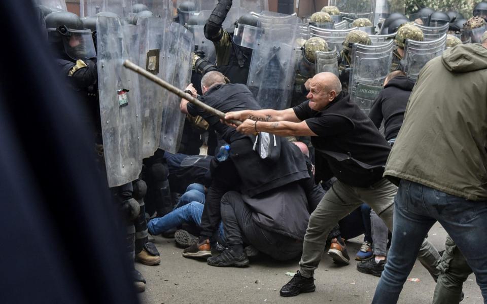 Nato soldiers clash with protesters outside the municipal office in Zvecan on Monday - REUTERS