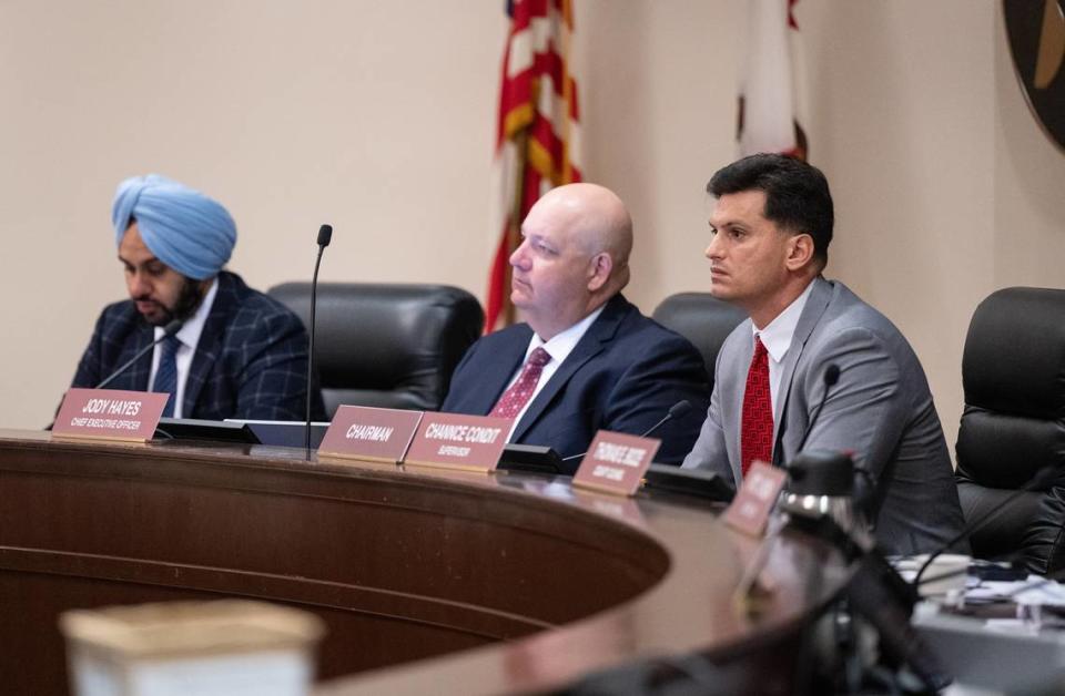 Supervisor Channce Condit right, CEO Jody Hayes, middle, and supervisor Mani Grewal, left, listen to public comment during a board meeting in Modesto, Calif., Tuesday, June 6, 2023.
