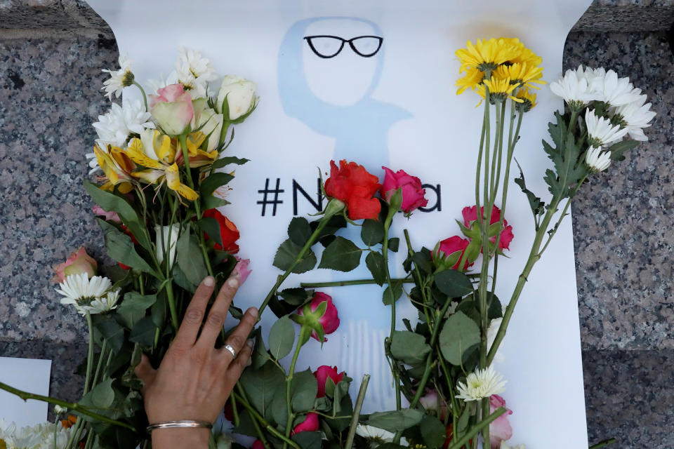 An attendee leaves flowers for Nabra Hassanen, a teenage Muslim girl killed by a bat-wielding motorist near a Virginia mosque, during a vigil in New York City on June 20, 2017.