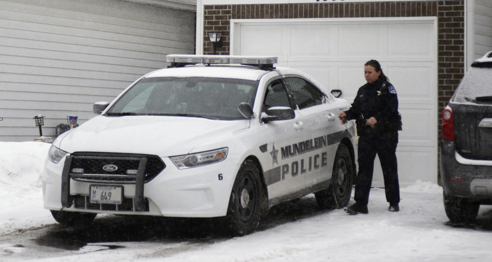 A police officer is seen outside a home in Mundelein, Ill., Wednesday, Jan. 22, 2014, where an 11-year-old girl was stabbed to death on Tuesday, Jan. 21. The Lake County State's Attorney's office said Wednesday they've approved a first-degree murder charge against a 14-year-old girl in the killing. A juvenile court judge will decide whether to confirm the charge and keep the teenager in custody at a closed hearing Wednesday afternoon. Authorities haven't released details on the girls or how they're related. But officials say both girls lived in the same Mundelein home, about 30 miles northwest of Chicago. No parent was home at the time of the slaying. (AP Photo/Daily Herald, Paul Valade) MANDATORY CREDIT, MAGS OUT