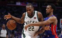 Detroit Pistons guard Ish Smith knocks the ball away from Milwaukee Bucks forward Khris Middleton (22) during the first half of Game 3 of a first-round NBA basketball playoff series, Saturday, April 20, 2019, in Detroit. (AP Photo/Carlos Osorio)