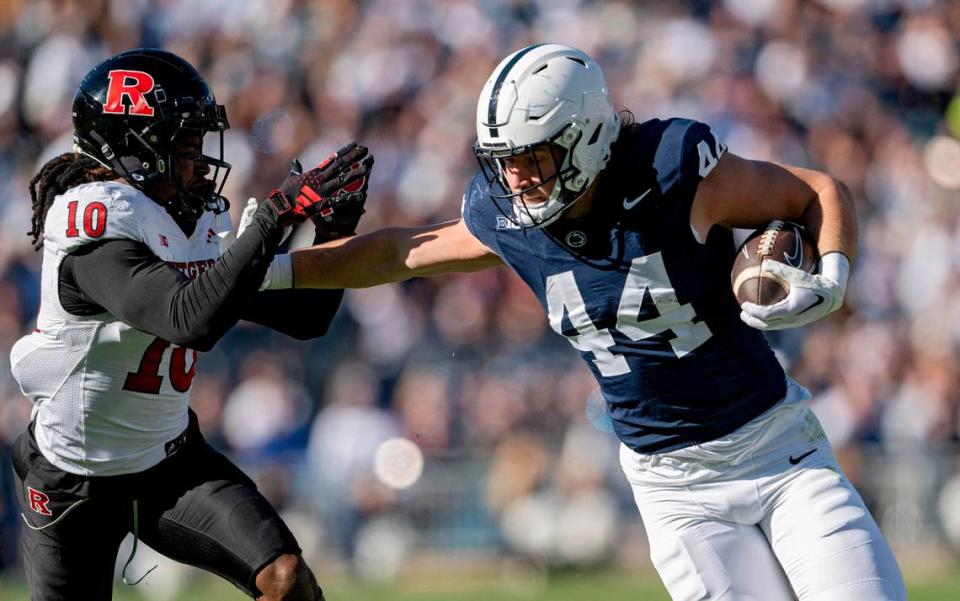Penn State tight end Tyler Warren makes a catch and pushes past Rutgers Flip Dixon during the game on Saturday, Nov. 18, 2023.