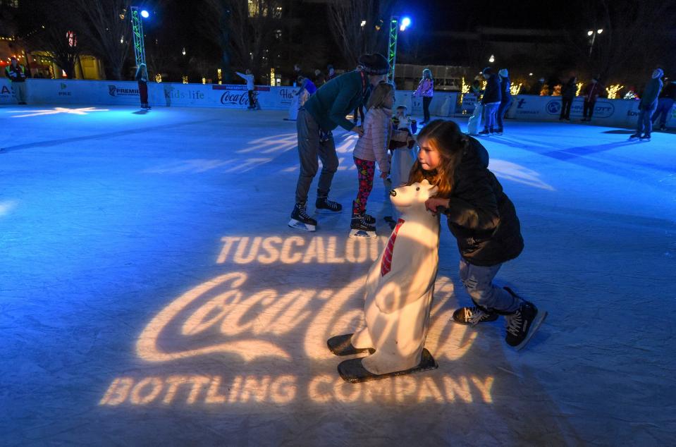Dec 15, 2022; Tuscaloosa, Alabama, USA;  Kynlei Parsons, 8, enjoys the ice rink which is part of the Holidays on the Plaza at Government Plaza in Tuscaloosa.
