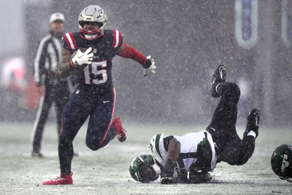 New England Patriots running back Ezekiel Elliott (15) breaks free from New York Jets linebacker C.J. Mosley, right, during the first half of an NFL football game, Sunday, Jan. 7, 2024, in Foxborough, Mass. (AP Photo/Steven Senne)