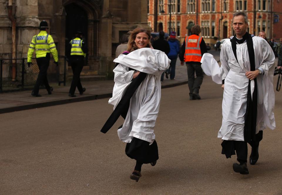 Members of the clergy rush towards York Minster before a service to consecrate Reverend Libby Lane as the first female Bishop in the Church of England in York