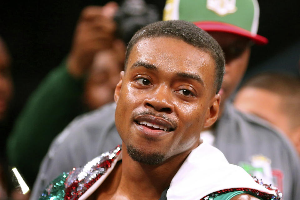 FILE - In this March 16, 2019, file photo, Errol Spence Jr. gestures for the TV cameras before an IBF World Welterweight Championship boxing bout against Mikey Garcia, in Arlington, Texas. Authorities say welterweight boxing champion Errol Spence crashed a speeding Ferrari in Dallas and is badly injured but expected to survive. Police say the crash happened just before 3 a.m. Thursday, Oct. 10, 2019, when Spence's Ferrari crossed the median into oncoming traffic and flipped over several times.Spence was taken to a hospital where he was in the intensive care unit Thursday morning. (AP Photo/Richard W. Rodriguez, File)