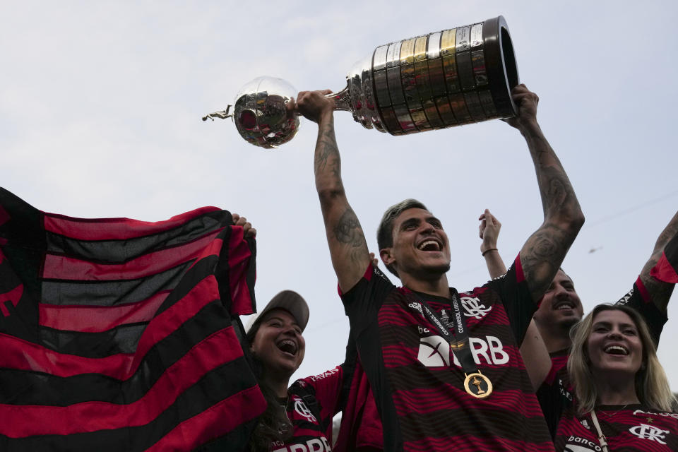 Pedro of Brazil's Flamengo celebrates with the trophy after winning the Copa Libertadores final soccer match against Brazil's Athletico Paranaense at the Monumental Stadium in Guayaquil, Ecuador, Saturday, Oct. 29, 2022. (AP Photo/Dolores Ochoa)