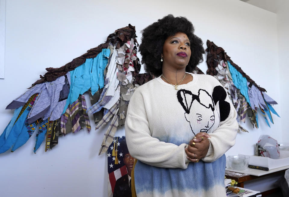 Artist Patrisse Cullors poses in front of her sculpture "A Prayer to the Iyami" at her studio, Friday, March 24, 2023, in Los Angeles. Cullers wore the sculpture for a performance during a retrospective for the Iranian visual artist Shirin Nesat in February 2020. (AP Photo/Chris Pizzello)