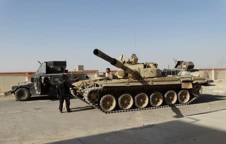 Vehicles of the Iraqi security forces are seen during a patrol on the outskirts of Ramadi September 19, 2014. REUTERS/Osama Al-dulaimi