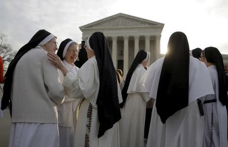 Nuns speak to each other before Zubik v. Burwell, an appeal brought by Christian groups demanding full exemption from the requirement to provide insurance covering contraception under the Affordable Care Act, is heard by the U.S. Supreme Court in Washington, March 23, 2016. REUTERS/Joshua Roberts