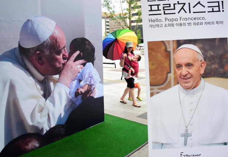 A poster advertises a Pope Francis photo exhibition is displayed in Seoul on August 8, 2014