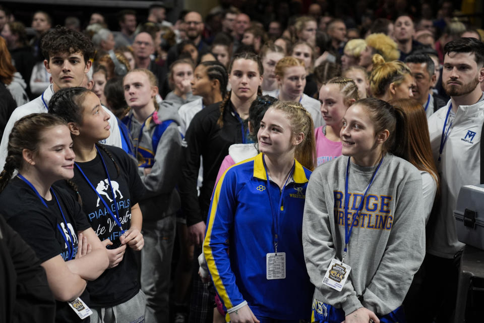 Competitors wait to go onto the mats for Pennsylvania's first state-sanctioned girls' PIAA High School Wrestling Championships in Hershey, Pa., Thursday, March 7, 2024. (Girls’ wrestling has become the fastest-growing high school sport in the country. (AP Photo/Matt Rourke)