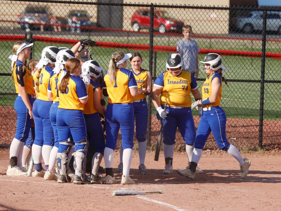 West Muskingum's Addy Antonetz, far right, is mobbed at home plate by teammates after a third-inning home run in a 12-0 mercy win against host Crooksville on Monday in McLuney. Antonetz has been a catalyst at the top of the order for the Tornadoes, whose offense has overwhelmed opponents this season.