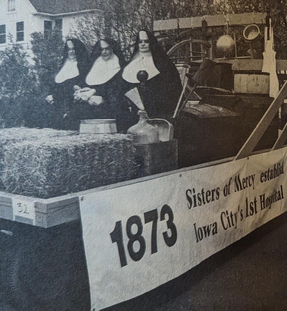 During the Iowa City sesquicentennial parade in 1989, Mercy Hospital staff members created a float on a horse-drawn wagon to reenact the founding of the hospital with three riders modeling the original habits of the early era.
