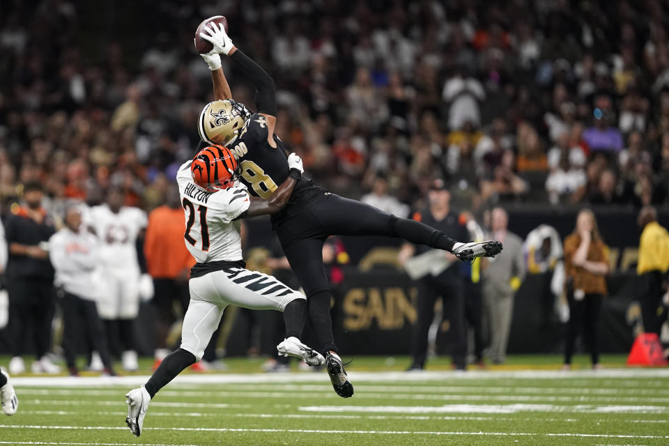 New Orleans Saints wide receiver Keith Kirkwood (18) catches a pass as Cincinnati Bengals cornerback Mike Hilton (21) defends during the second half of an NFL football game in New Orleans, Sunday, Oct. 16, 2022. (AP Photo/Gerald Herbert)