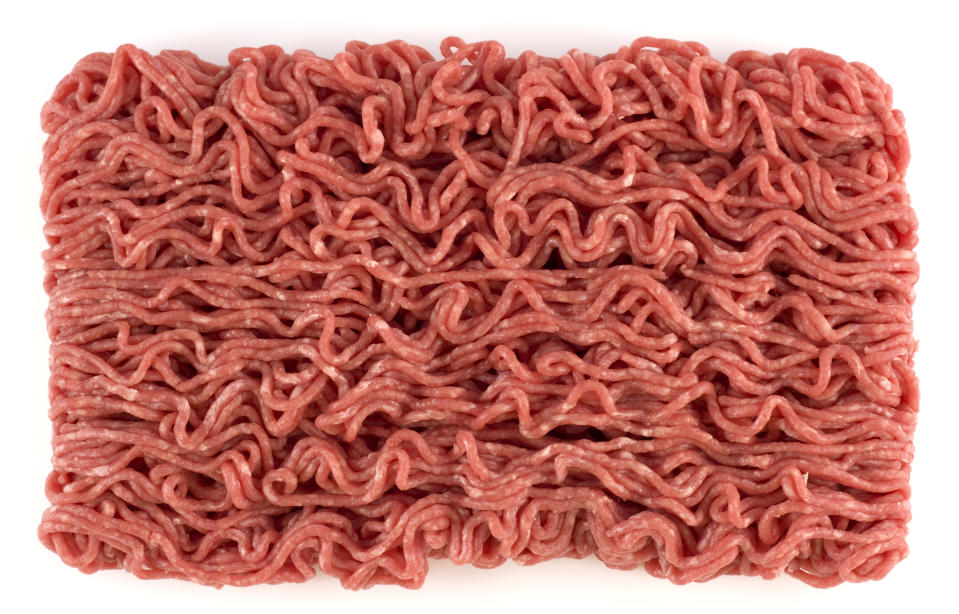 Slab of mince beef on a white background.