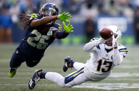 Keenan Allen #13 of the Los Angeles Chargers attempts to make a catch while being guarded by Shaquill Griffin #26 of the Seattle Seahawks in the second quarter at CenturyLink Field - Credit: Otto Greule Jr/Getty Images